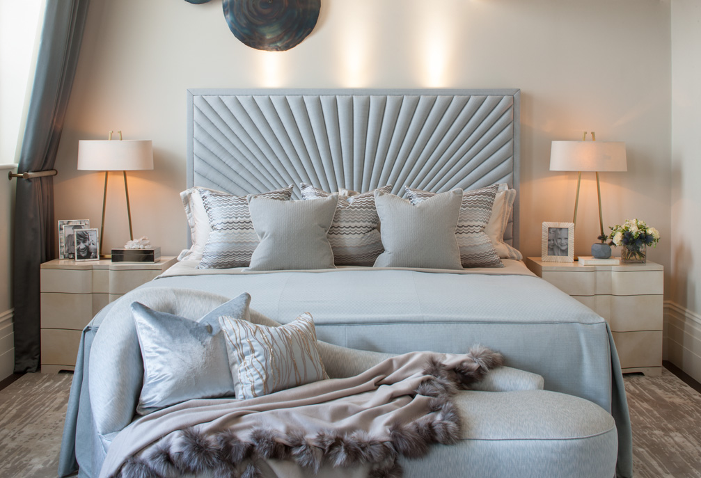 neutral-primary-bedroom-fan-headboard-layered-bedding