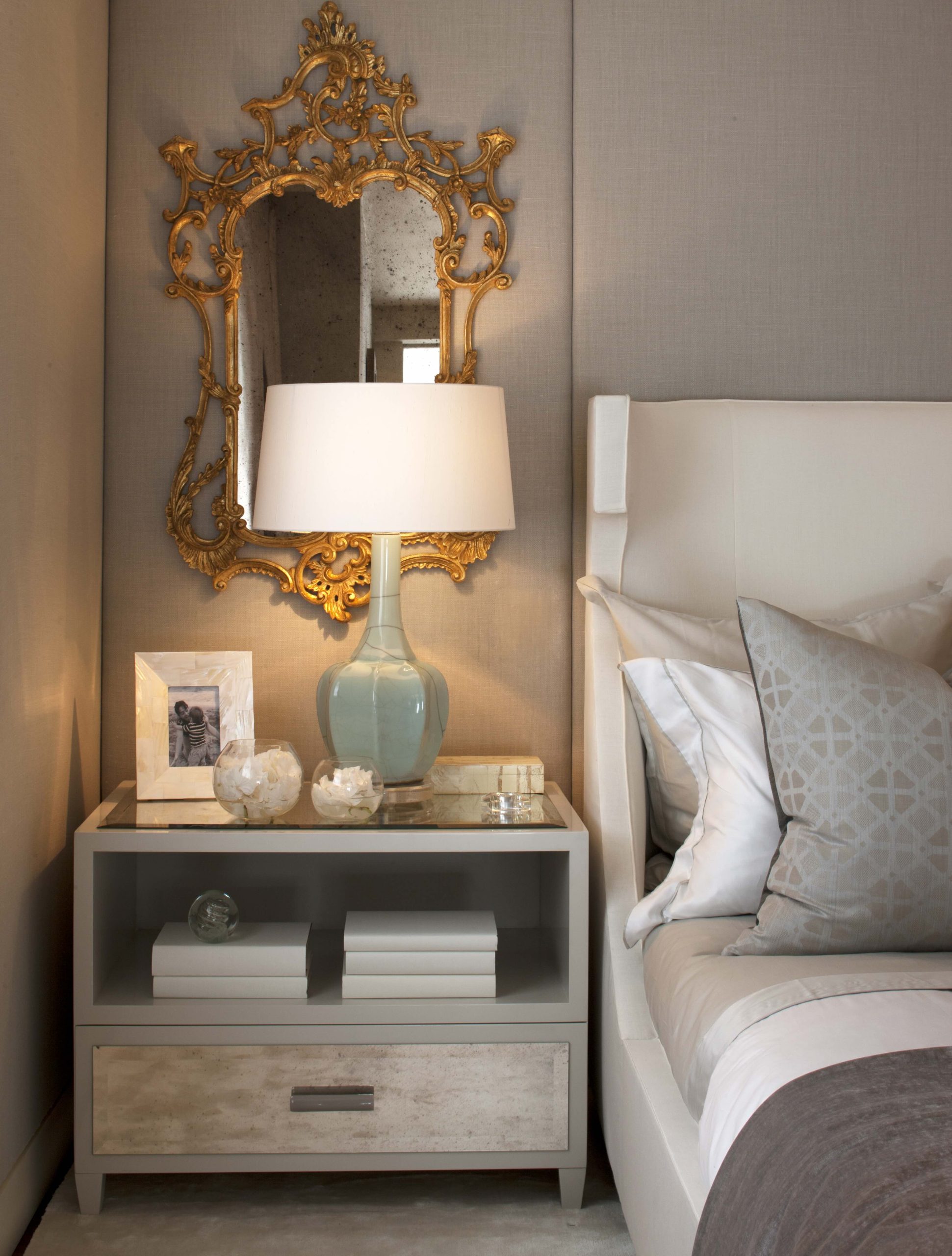 ornate-mirror-bedside-lamp-luxury-bedroom-detail