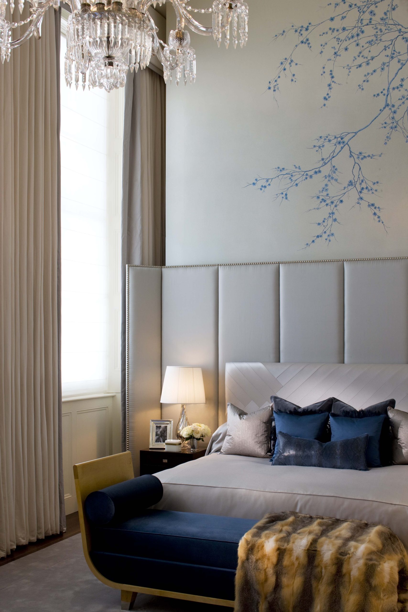 primary-bedroom-upholstered-headboard-chandelier-blue-accents